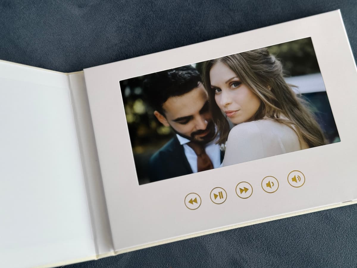 Wedding Video Book open showing a couple on the HD screen